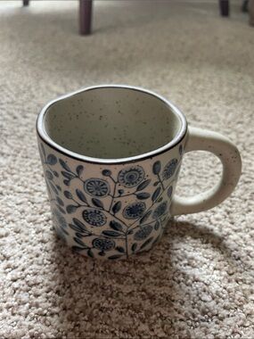 Speckled Ceramic Mug with Blue Floral Pattern